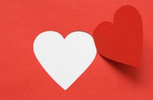 Red paper background with cutting heart. Image with clipping path for your design ideas